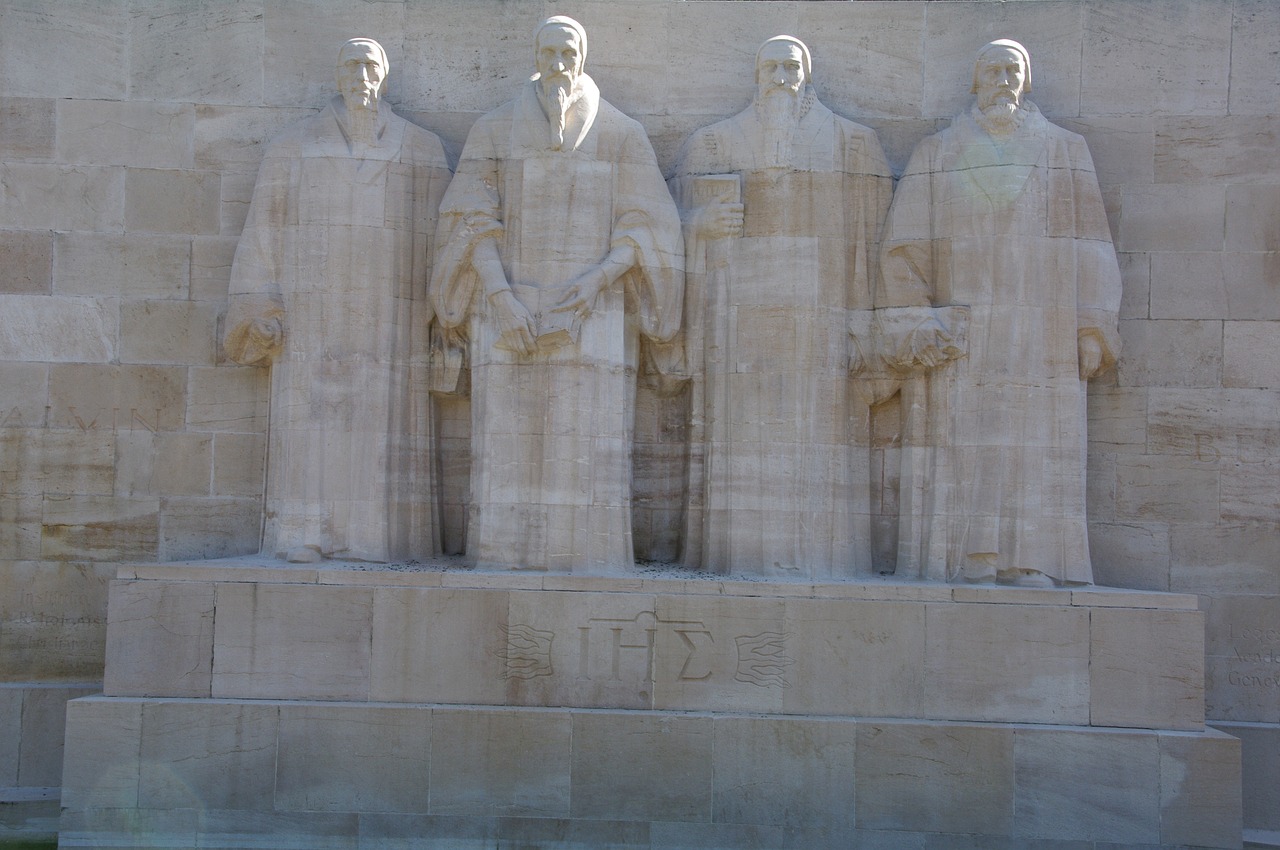Zoom56 Calvin a group of statues of men standing next to each other