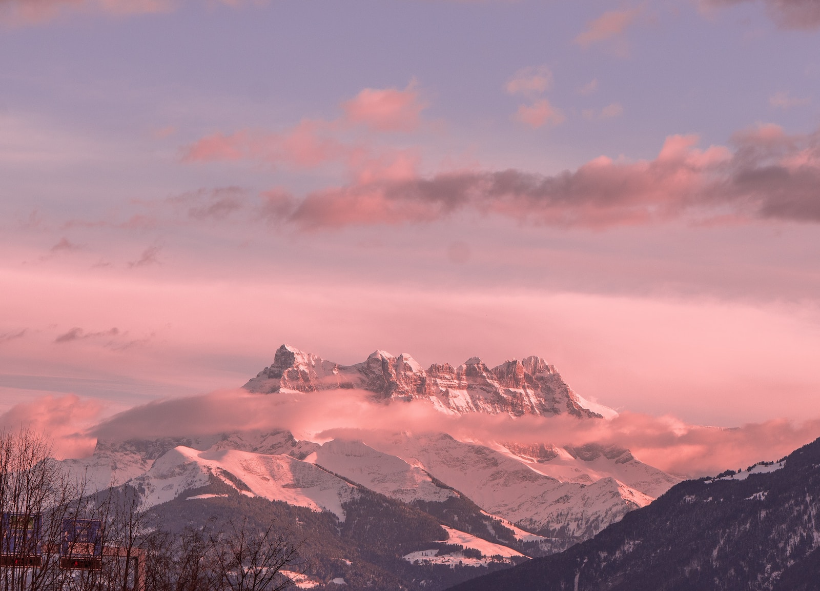 Photo by Michel Grolet snow covered mountains under cloudy sky during daytime