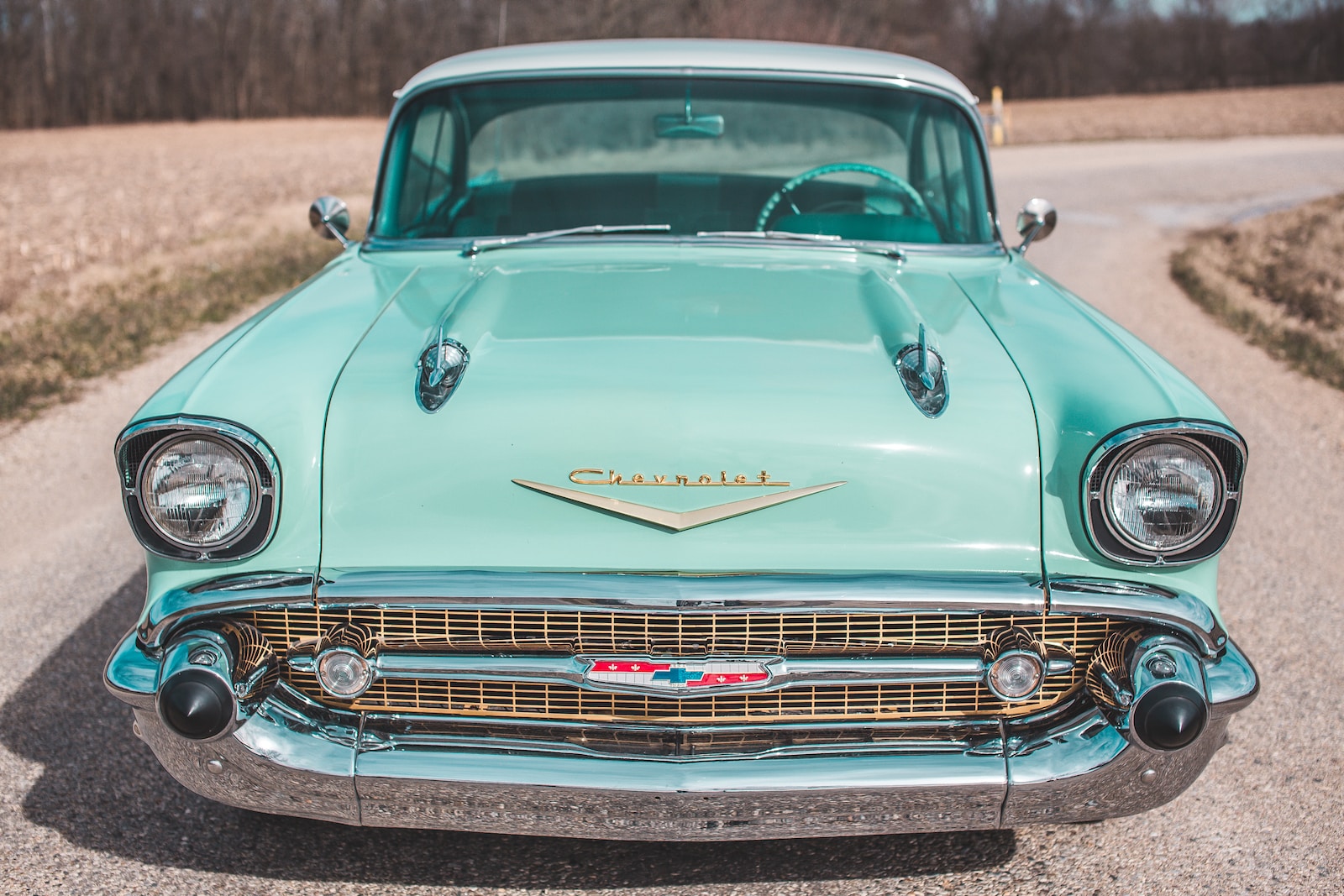 Photo by Courtney Cook vintage green car on road
