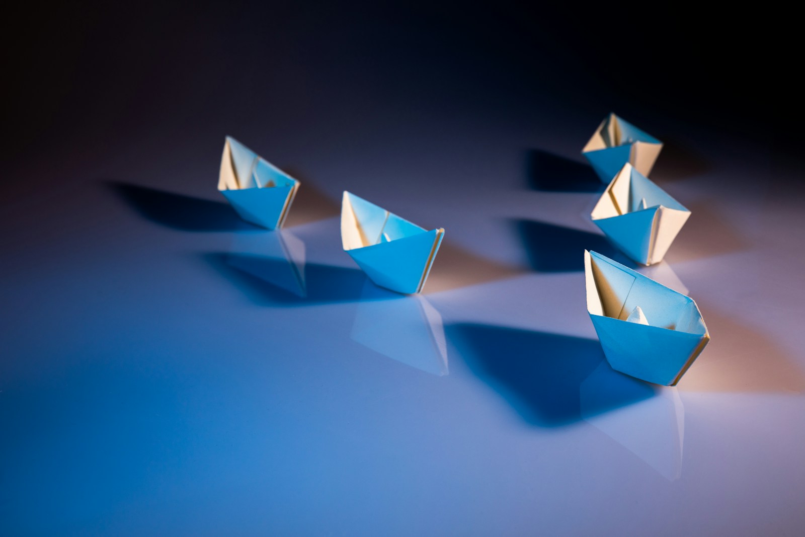 Photo by KOBU Agency white paper boats on white surface